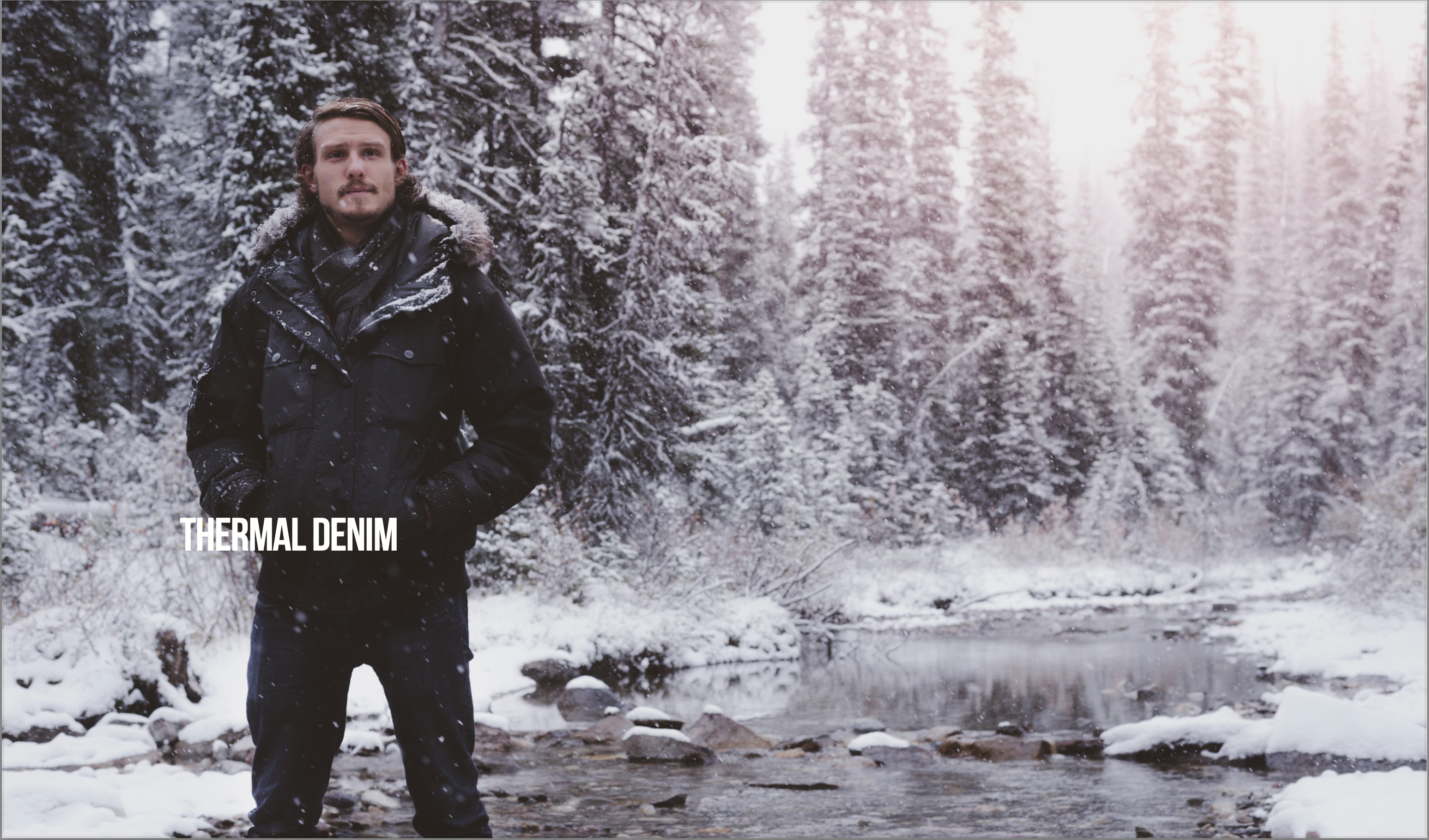 Model wearing thermal denim in the woods that's cold and filled with snow and ice. 